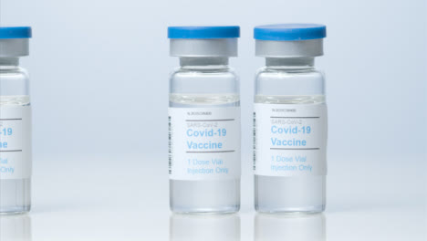 Sliding-Close-Up-Shot-of-Three-Vials-of-Coronavirus-Vaccine-