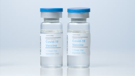Sliding-Close-Up-Shot-of-Three-Vials-of-a-Coronavirus-Vaccine-