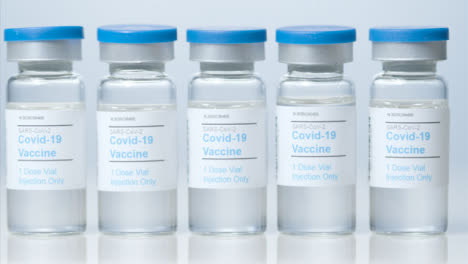 Sliding-Close-Up-Shot-of-Five-Vials-of-Covid-Vaccine-