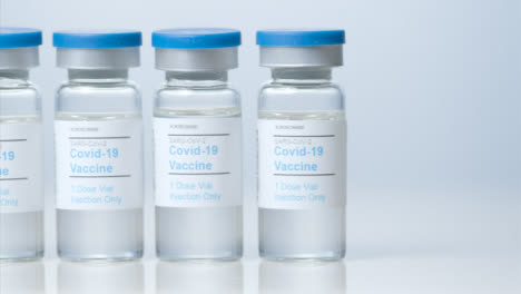 Sliding-Close-Up-Shot-of-Five-Vials-of-Covid-19-Vaccine-