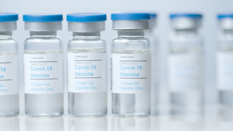 Sliding-Close-Up-Shot-of-Five-Vials-of-Coronavirus-Vaccine-