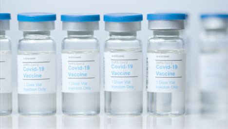 Sliding-Close-Up-Shot-of-Four-Vials-of-Coronavirus-Vaccine-