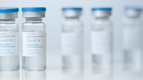 Sliding-Close-Up-Shot-of-Four-Vials-of-Covid-19-Vaccine-