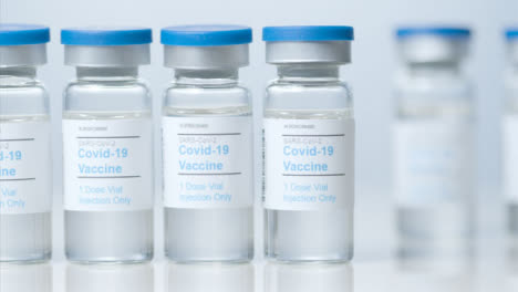 Sliding-Close-Up-Shot-of-Five-Vials-of-a-Covid-19-Vaccine-