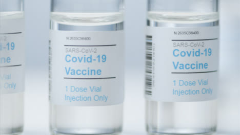 Sliding-Extreme-Close-Up-Shot-of-Vials-Containing-Covid-19-Vaccine