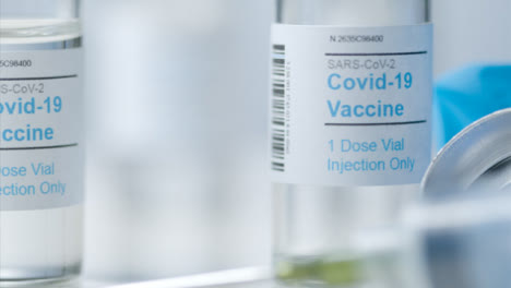 Sliding-Extreme-Close-Up-Shot-of-Vials-Containing-Covid-Vaccine