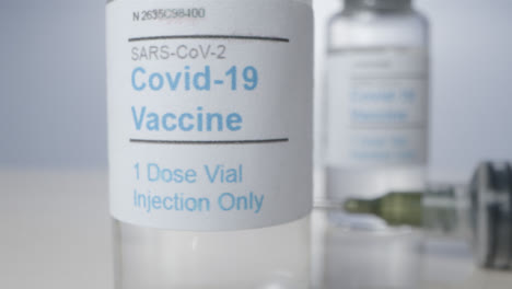 Sliding-Extreme-Close-Up-Shot-Through-Several-Vials-of-Covid-19-Vaccine