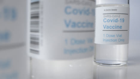 Sliding-Extreme-Close-Up-Shot-Past-Multiple-Vials-of-Covid-Vaccine-with-Right-Copy-Space