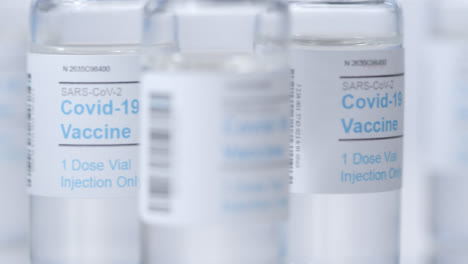 Sliding-Extreme-Close-Up-Shot-Past-Multiple-Vials-of-Covid-19-Vaccine