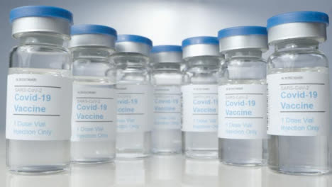 Sliding-Close-Up-Shot-Revealing-Several-Vials-of-Covid-Vaccine