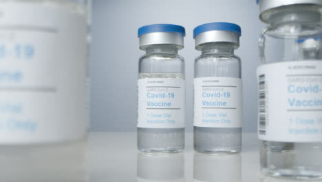 Sliding-Close-Up-Shot-of-Vials-of-Coronavirus-Vaccine-
