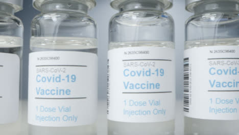 Sliding-Extreme-Close-Up-Shot-Along-Line-of-Covid-19-Vaccine-Vials