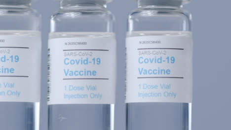 Sliding-Extreme-Close-Up-Shot-Along-Line-of-Covid-Vaccine-Vials