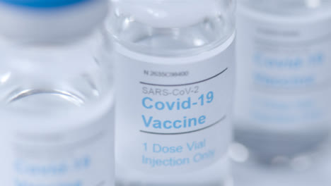 Sliding-Extreme-Close-Up-Shot-of-Several-Covid-19-Vaccine-Vials-