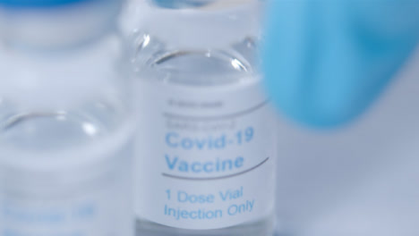 Sliding-Extreme-Close-Up-Shot-of-Several-Covid-Vaccine-Vials-