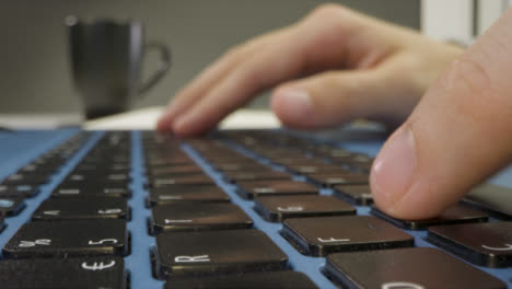 Sliding-Extreme-Close-Up-Shot-of-Male-Hands-Typing-On-Laptop-Keyboard