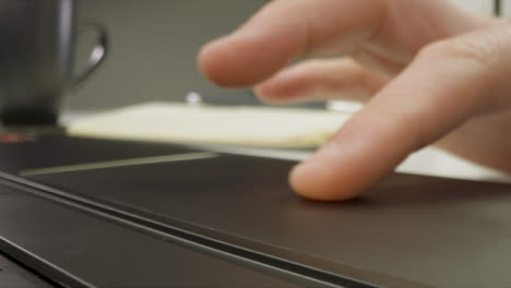Sliding-Extreme-Close-Up-Shot-of-Male-Hands-Using-Laptop-Keyboard-and-Trackpad