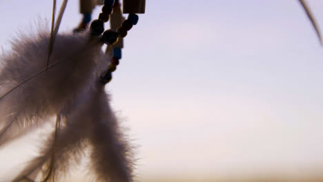 Extreme-Close-Up-Shot-of-Dreamcatcher-Feathers-Swaying-In-the-Wind