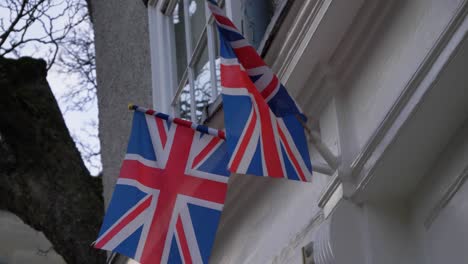 Handheld-Close-Up-Shot-of-United-Kingdom-Flags-Swaying-