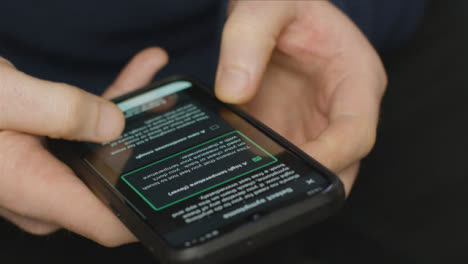 Close-Up-of-Hands-Using-COVID-19-Lockdown-Smartphone-Application