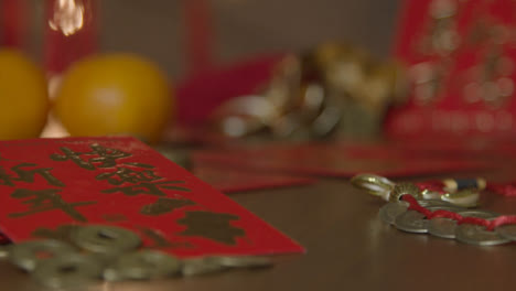 Sliding-Close-Up-Shot-of-Chinese-New-Year-Red-Packets-and-Coins