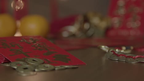 Sliding-Close-Up-Shot-of-Chinese-New-Year-Red-Packets-and-Coins