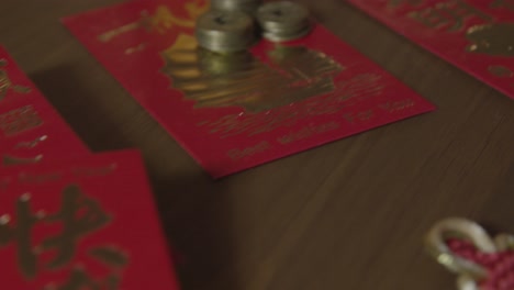 Sliding-Extreme-Close-Up-Shot-of-Chinese-New-Year-Red-Pockets-and-Coins