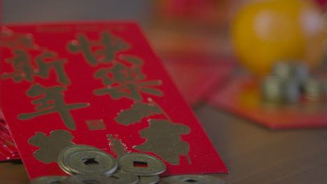 Sliding-Shot-Gliding-Over-Chinese-New-Year-Red-Pockets-and-Coins