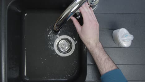 Top-Down-Shot-of-Male-Hands-Washing-Under-Running-Tap
