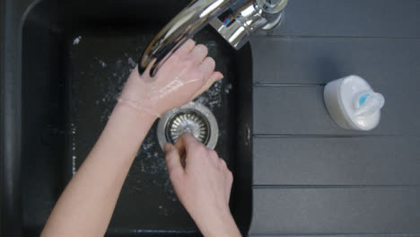 Top-Down-Shot-of-Female-Hands-Washing-Under-Running-Tap-with-Soap