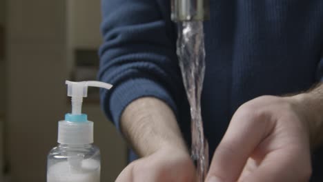 Close-Up-Shot-of-Male-Hands-Washing-Under-Running-Kitchen-Tap-with-Soap