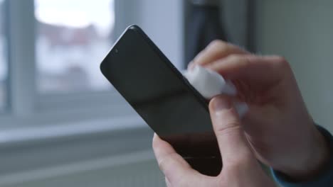 Close-Up-Shot-of-Male-Hands-Cleaning-a-Phone-Screen-with-Anti-Bacterial-Wipe