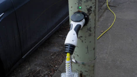 Tracking-Shot-Orbiting-On-Street-Electric-Car-Charging-Point-