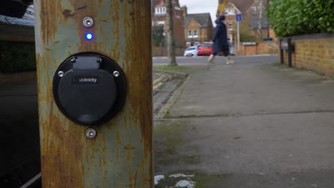 Pedestal-Shot-Rising-Up-and-Looking-at-On-Street-Electric-Car-Charging-Point