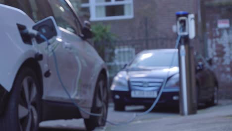 Defocused-Low-Angle-Shot-of-Electric-Car-Charging-On-Street-
