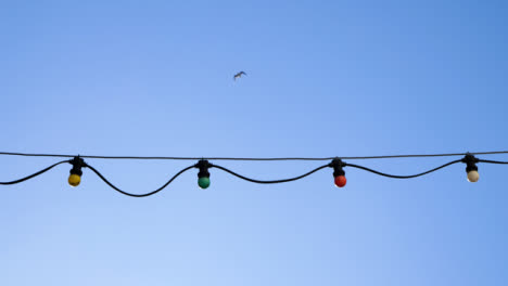 Handheld-Low-Angle-Shot-Looking-Up-at-Outdoor-Festive-Lights-
