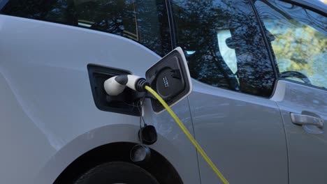 Low-Angle-Shot-Looking-Up-at-Charging-Cable-Plugged-into-Electric-Car