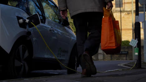Low-Angle-Wide-Shot-of-Electric-Car-Using-On-Street-Charging-Point