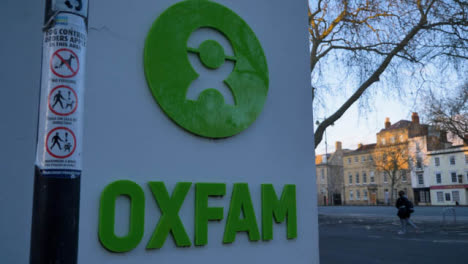 Handheld-Wide-Shot-of-Oxfam-Shop-Sign-