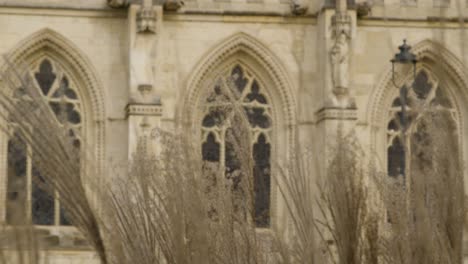 Pull-Focus-Shot-Through-Grass-Looking-at-Gloucester-Cathedral