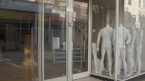 Medium-Shot-of-Mannequins-In-Closed-Down-Shop-Window