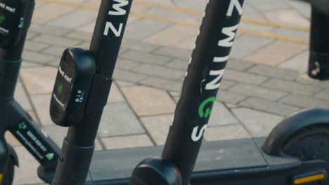 Pull-Focus-Close-Up-Shot-of-Stationary-Electric-Scooters