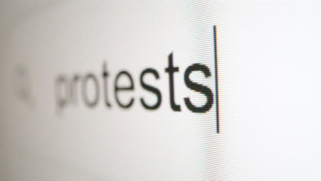 Extreme-Close-Up-Typing-Protests-Near-Me-in-Google-Search-Bar