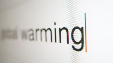 Extreme-Close-Up-Typing-Global-Warming-in-Google-Search-Bar