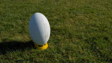 Medium-Shot-of-Rugby-Ball-Sitting-On-Tee