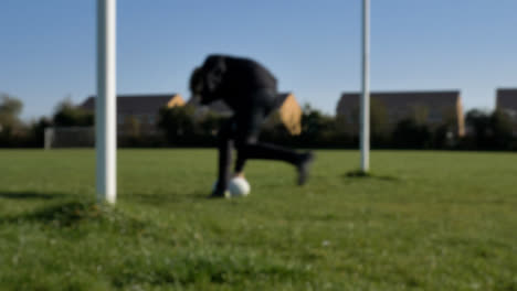 Defocused-Shot-of-Rugby-Player-Practicing-
