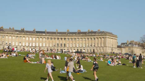 Panning-Shot-of-a-Large-Number-of-Pedestrians-On-Royal-Crescent-Green