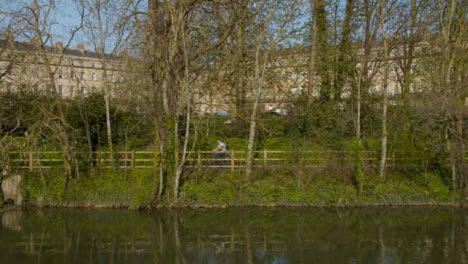 Wide-Shot-of-Cyclist-Riding-Along-River-Avon-Footpath