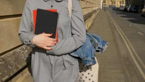 Tracking-Shot-Following-Young-Student-Holding-Books-In-Her-Hands