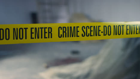 Close-Up-Shot-of-Crime-Scene-Tape-In-Disused-Warehouse